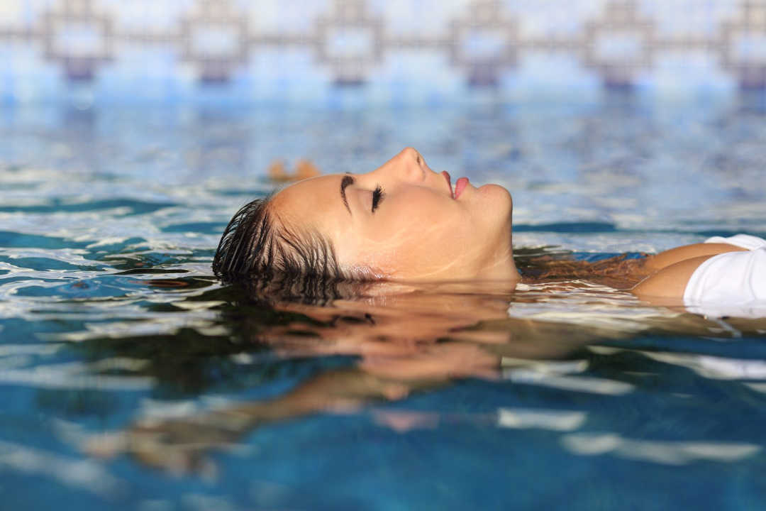 Woman floating in pool 